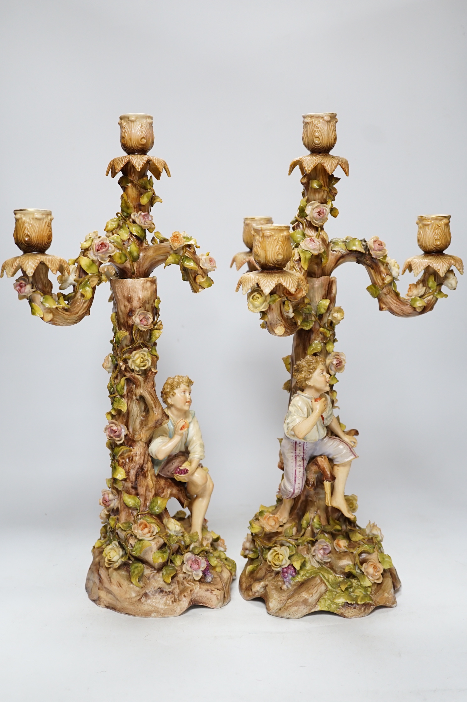 A pair of Sitzendorf / Plaue figural and floral encrusted candelabra, 47cm high